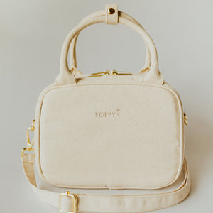 Natural color Everyday Poppy Bag with gold accents, top handle, and crossbody strap
