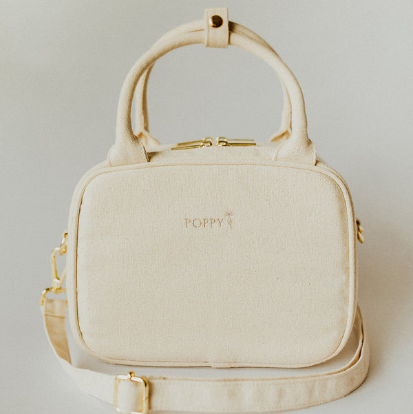 Natural color Everyday Poppy Bag with gold accents, top handle, and crossbody strap